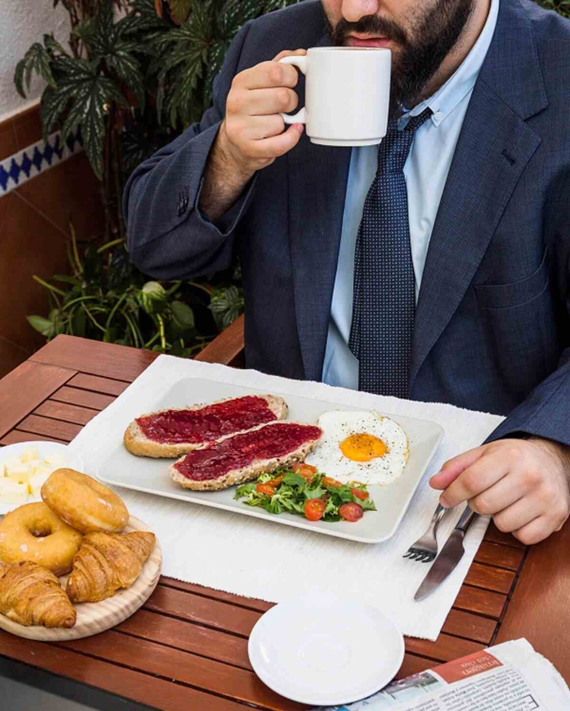 man drinking tea with fresh food